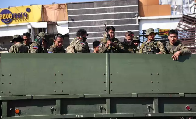 Soldiers secure a damaged building following an earhtquake in General Santos, Philippines Tuesday, June 9, 2026. (AP Photo/Basilio Sepe)