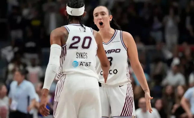 Toronto Tempo's Marina Mabrey (3) and Brittney Sykes (20) celebrate during overtime WNBA action against Connecticut Sun in Toronto, Ontario, Wednesday, June 10, 2026. (Frank Gunn/The Canadian Press via AP)