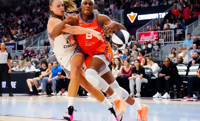 Toronto Tempo's Laura Juskaite (2) fouls Connecticut Sun forward Aaliyah Edwards (8) during the first half of WNBA basketball game in Toronto, Wednesday, June 10, 2026. (Frank Gunn/The Canadian Press via AP)
