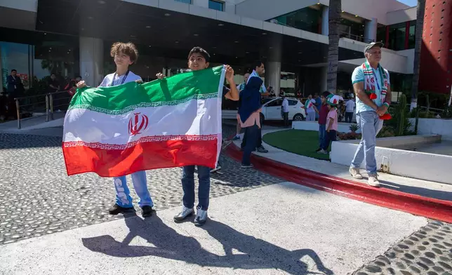 Children cheer for the Iran national soccer team as they depart from the Tijuana Marriott in Tijuana, Mexico on Saturday June 20, 2026. (AP Photo/Gabriela Aoun Angueira)