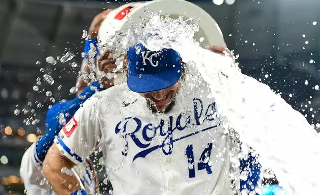 Kansas City Royals' Jac Caglianone is doused by teammates after their baseball game against the Texas Rangers, Tuesday, June 9, 2026, in Kansas City, Mo. (AP Photo/Charlie Riedel)