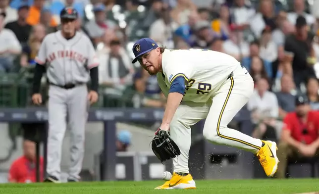 Milwaukee Brewers' Chad Patrick is unable to field a bunt hit by San Francisco Giants' Jung Hoo Lee during the eighth inning of a baseball game Wednesday, June 3, 2026, in Milwaukee. (AP Photo/Aaron Gash)