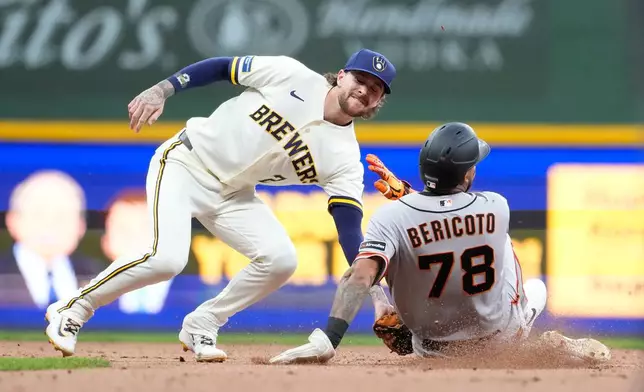 Milwaukee Brewers' Brice Turang (2) tags out San Francisco Giants' Victor Bericoto (78) at second base during the seventh inning of a baseball game Wednesday, June 3, 2026, in Milwaukee. (AP Photo/Aaron Gash)