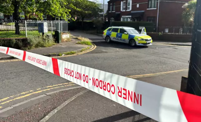 A police cordon at the scene of a stabbing outside apartments in north Belfast, Tuesday, June 3, 2026. (Rebecca Black/PA via AP)