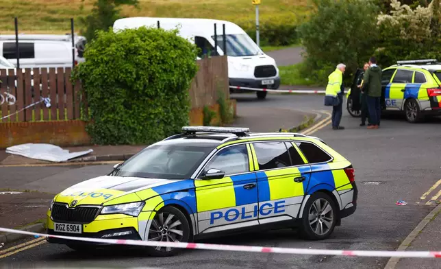 Members of the Police Service of Northern Ireland secure the area around the scene of a stabbing in North Belfast, Tuesday, June 9, 2026. (AP Photo/Peter Morrison)