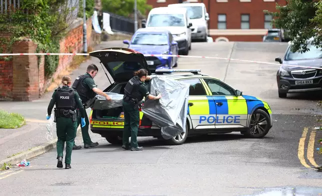 Members of the Police Service of Northern Ireland secure the area around the scene of a stabbing in North Belfast, Tuesday, June 9, 2026. (AP Photo/Peter Morrison)