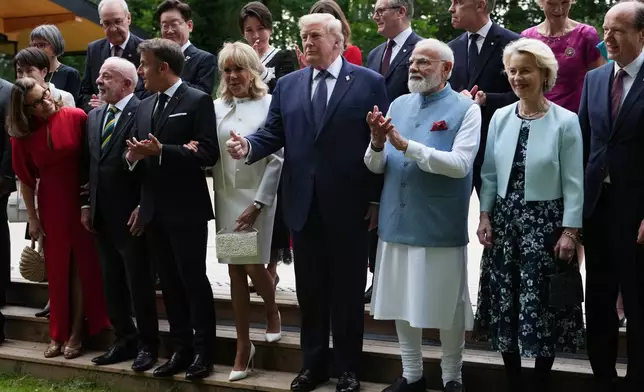 U.S. President Donald Trump and other leaders pose during a group photo of leaders at the G7 summit, Tuesday, June 16, 2026, in Evian-les-Bains, France. (AP Photo/Julia Demaree Nikhinson)