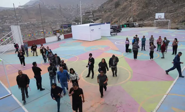 Voters arrive at a polling station during the presidential runoff election in Lima, Peru, Sunday, June 7, 2026. (AP Photo/Rodrigo Abd)