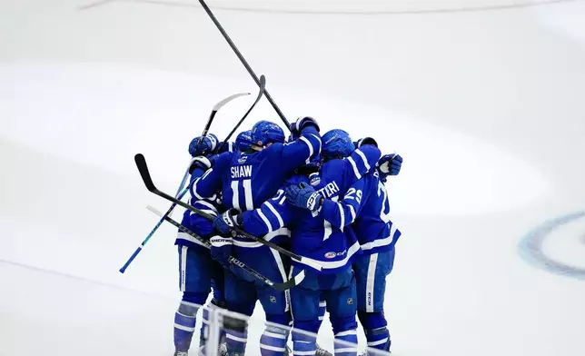 Toronto Marlies' Vinni Lettieri (71) celebrates with his teammates after scoring a goal on the Chicago Wolves during the second period in Game 5 of the AHL hockey Calder Cup final in Toronto, Friday, June 19, 2026. (Arlyn McAdorey/The Canadian Press via AP)