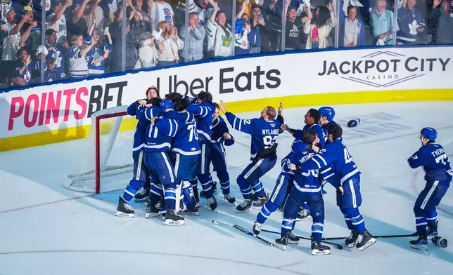 The Toronto Marlies celebrate after winning Game 5 of the AHL hockey Calder Cup final over the Chicago Wolves in Toronto, Friday, June 19, 2026. (Arlyn McAdorey/The Canadian Press via AP)