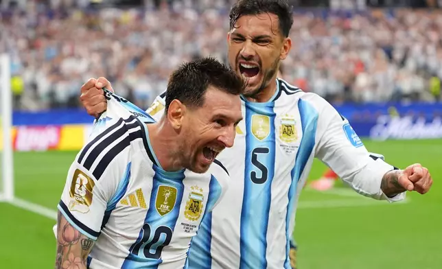 Argentina's Lionel Messi, left, celebrates with Leandro Paredes after scoring his side's second goal during the World Cup Group J soccer match between Argentina and Austria in Arlington, Texas, near Dallas, Monday, June 22, 2026. (AP Photo/Julio Cortez)