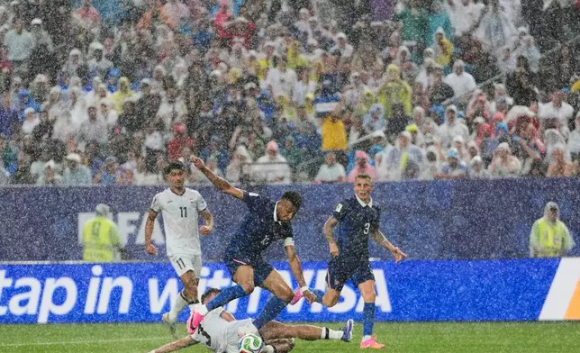 Iraq's Hussein Ali, bottom, challenges France's Kylian Mbappe during the World Cup Group I soccer match between France and Iraq in Philadelphia, Monday, June 22, 2026. (AP Photo/Matt Slocum)