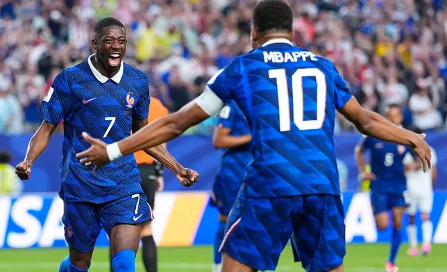 France's Ousmane Dembele (7) congratulates teammate Kylian Mbappe (10) after he scored their second goal during the World Cup Group I soccer match between France and Iraq in Philadelphia, Monday, June 22, 2026. (AP Photo/Petr David Josek)