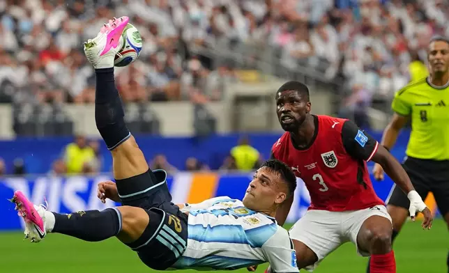 Argentina's Lautaro Martinez takes an overhead kick next to Austria's Kevin Danso during the World Cup Group J soccer match between Argentina and Austria in Arlington, Texas, near Dallas, Monday, June 22, 2026. (AP Photo/Julio Cortez)