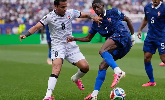 Iraq's Ibrahim Bayesh, left, and France's Ousmane Dembele vie for the ball during the World Cup Group I soccer match between France and Iraq in Philadelphia, Monday, June 22, 2026. (AP Photo/Matt Slocum)