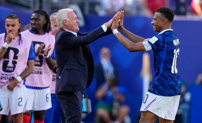 France's Kylian Mbappe, right, celebrates with France head coach Didier Deschamps after scoring his side's third goal during the World Cup Group I soccer match between France and Senegal in East Rutherford, N.J., near New York, Tuesday, June 16, 2026. (AP Photo/Frank Franklin II)