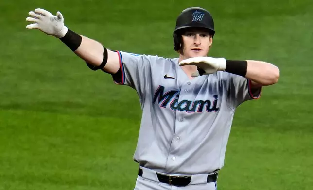 Miami Marlins' Owen Caissie celebrates as he stands on second base after driving in two runs with a double off Pittsburgh Pirates pitcher Wilber Dotel during the seventh inning of a baseball game in Pittsburgh, Friday, June 12, 2026. (AP Photo/Gene J. Puskar)