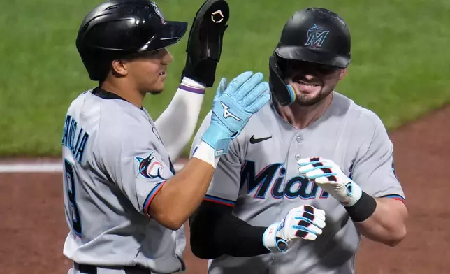 Miami Marlins' Liam Hicks, right, celebrates with Javier Sanoja as he returns to the dugout after hitting a two-run home run off Pittsburgh Pirates pitcher Antwone Kelly during the eighth inning of a baseball game in Pittsburgh, Friday, June 12, 2026. (AP Photo/Gene J. Puskar)