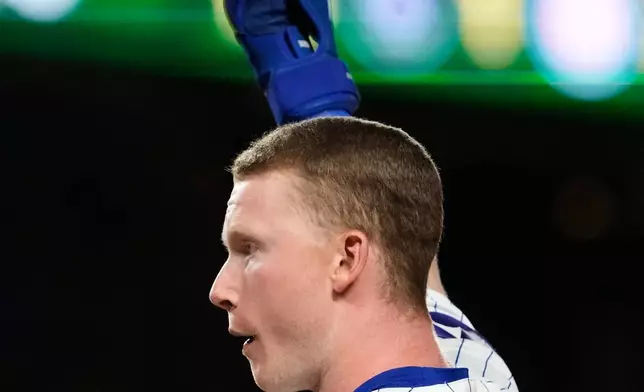 Chicago Cubs' Pete Crow-Armstrong waves to fans after hitting a single to complete the cycle during the seventh inning of a baseball game against the Colorado Rockies in Chicago, Monday, June 15, 2026. (AP Photo/Nam Y. Huh)