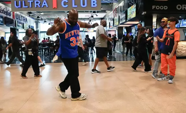 A New York Knicks fan arrives prior to Game 1 of the NBA Finals basketball series against the San Antonio Spurs, Wednesday, June 3, 2026, in San Antonio. (AP Photo/David J. Phillip)