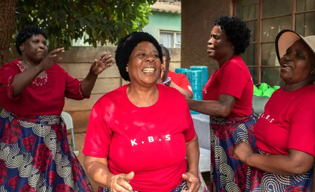 Kuchemana Burial Society members sing and dance during a meeting in Harare, Zimbabwe, March 13, 2026. (AP Photo/Aaron Ufumeli)