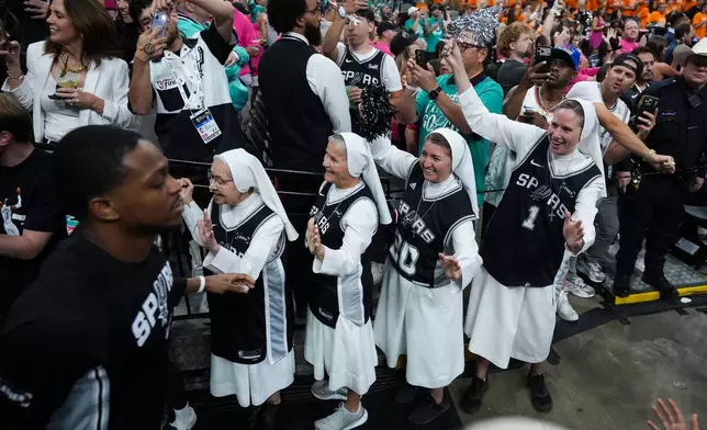 The Salesian Sisters greet players prior to Game 1 of the NBA Finals basketball series between the New York Knicks and the San Antonio Spurs, Wednesday, June 3, 2026, in San Antonio. (AP Photo/Eric Gay)