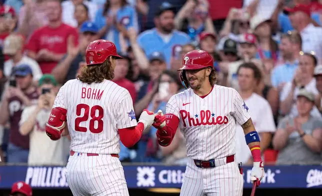 Philadelphia Phillies' Alec Bohm, left, and Bryson Stott celebrate after Bohm's two-run home run against Miami Marlins pitcher Tyler Phillips during the second inning of a baseball game Tuesday, June 16, 2026, in Philadelphia. (AP Photo/Matt Slocum)