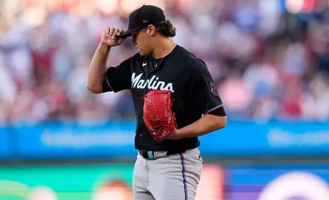 Miami Marlins pitcher Tyler Phillips adjusts his hat after giving up a two-run triple to Philadelphia Phillies' Bryson Stott during the first inning of a baseball game Tuesday, June 16, 2026, in Philadelphia. (AP Photo/Matt Slocum)