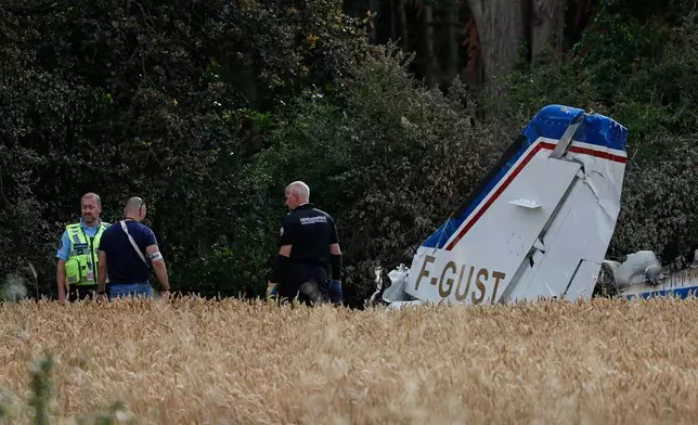 Forensic technicians examine the wreckage of the Cessna 421 piloted by Ubisoft co-founder Claude Guillemot, who was killed when the aircraft crashed while approaching La Baule-Escoublac airfield Friday evening in La Baule, western France, Saturday, June 20, 2026. (AP Photo/Jeremia Gonzalez)