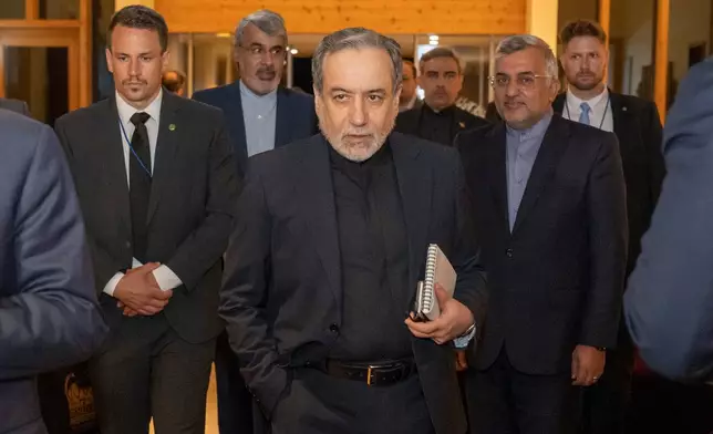 Iranian Foreign Minister Seyyed Abbas Araghchi, center, arrives at the Buergenstock resort in Obbuergen, near Lucerne, Switzerland, early Sunday, June 21, 2026. (Urs Flueeler/Keystone, Pool via AP)