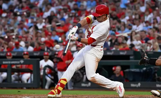 St. Louis Cardinals' Lars Nootbaar hits a sacrifice fly in the fifth inning of a baseball game against the San Diego Padres, Tuesday, June 16, 2026, in St. Louis. (AP Photo/Joe Puetz)