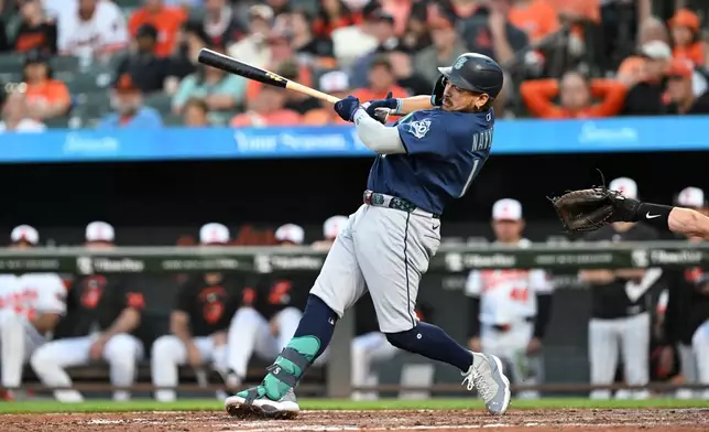 Seattle Mariners' Josh Naylor follows through on a grand slam against the Baltimore Orioles in the fifth inning of a baseball game, Monday, June 8, 2026, in Baltimore. (AP Photo/Gail Burton)