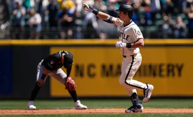 Seattle Mariners' Cole Young, right, rounds the bases after hitting a solo home run during the second inning of a baseball game against the Arizona Diamondbacks, Sunday, May 31, 2026, in Seattle. (AP Photo/Stephen Brashear)
