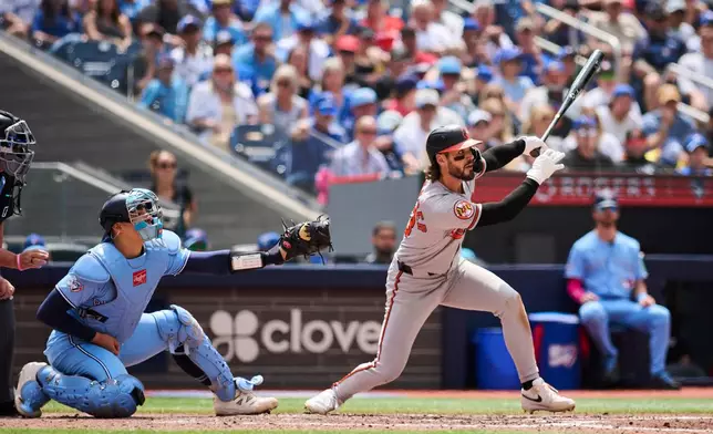 Baltimore Orioles' Blaze Alexander, right, watches his RBI double against the Toronto Blue Jays during fifth-inning baseball game action in Toronto, Sunday, June 7, 2026. (Sammy Kogan/The Canadian Press via AP)