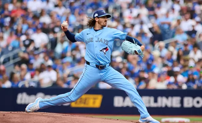 Toronto Blue Jays' Kevin Gausman (34) works against the Baltimore Orioles during first inning MLB baseball action in Toronto, Sunday, June 7, 2026. (Sammy Kogan/The Canadian Press via AP)