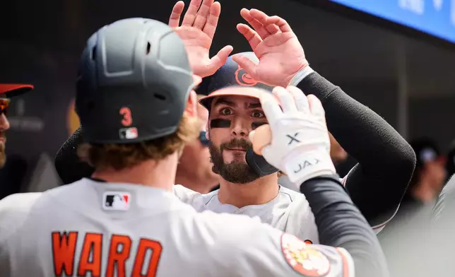 Baltimore Orioles' Taylor Ward (3) celebrates after his two-run home run with teammate Blaze Alexander, right, during fifth-inning baseball game action against the Toronto Blue Jays in Toronto, Sunday, June 7, 2026. (Sammy Kogan/The Canadian Press via AP)