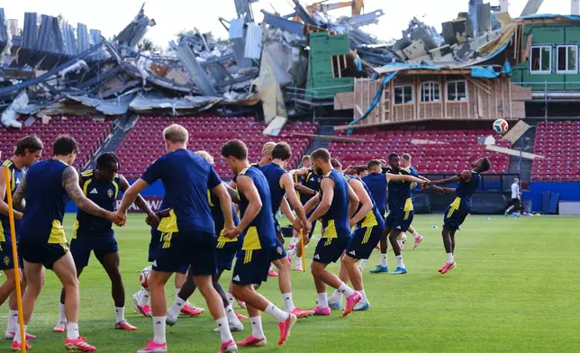 Demolition is visible to the stands at Toyota Stadium, home of MLS soccer's FC Dallas, as Sweden's Taha Ali, far right, tries to get to his head on the ball during a a training session ahead of Sweden's World Cup Group F soccer match against Japan, Wednesday, June 24, 2026, in Frisco, Texas. (AP Photo/Julio Cortez)