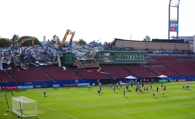 Demolition is visible to the stands at Toyota Stadium, home of MLS soccer's FC Dallas, as Sweden players participate in a training session ahead of their World Cup Group F soccer match against Japan, Wednesday, June 24, 2026, in Frisco, Texas. (AP Photo/Julio Cortez)