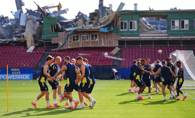 Demolition is visible to the stands at Toyota Stadium, home of MLS soccer's FC Dallas, as Sweden players participate in a training session ahead of their World Cup Group F soccer match against Japan, Wednesday, June 24, 2026, in Frisco, Texas. (AP Photo/Julio Cortez)