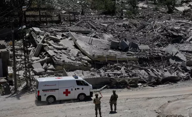 Lebanese soldiers deploy at a road in front of destroyed houses in Dibbine village, southeast Lebanon, Friday, June 5, 2026, a day after Israeli forces withdrew following clashes with Hezbollah fighters. (AP Photo/Hussein Malla)
