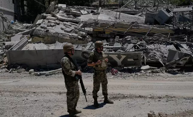 Lebanese army soldiers stand in front of a house that was destroyed in the recent clashes between Hezbollah fighters and Israeli troops in Dibbine village, southeast Lebanon, Friday, June 5, 2026, a day after Israeli forces withdrew. (AP Photo/Hussein Malla)