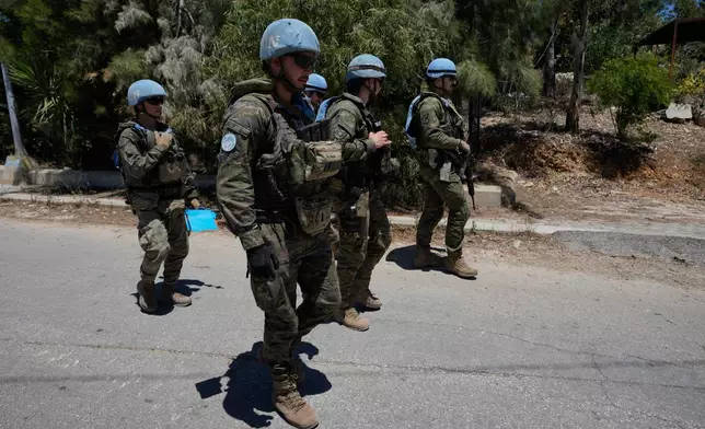 Spanish U.N peacekeepers patrol at an entrance of Dibbine village, southeast Lebanon, Friday, June 5, 2026, a day after Israeli forces withdrew following intense clashes with Hezbollah fighters. (AP Photo/Hussein Malla)
