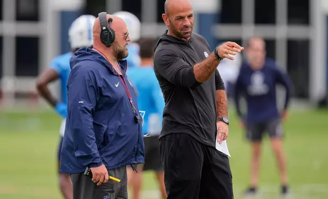 Tennessee Titans head coach Robert Saleh, right, talks to offensive coordinator Brian Daboll, left, during an NFL football practice Tuesday, June 9, 2026, in Nashville, Tenn. (AP Photo/George Walker IV)