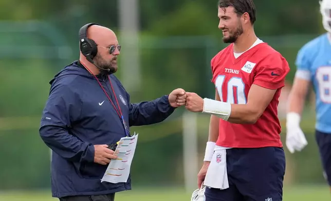 Tennessee Titans offensive coordinator Brian Daboll greets quarterback Mitch Trubisky (10) during an NFL football practice Monday, June 8, 2026, in Nashville, Tenn. (AP Photo/George Walker IV)