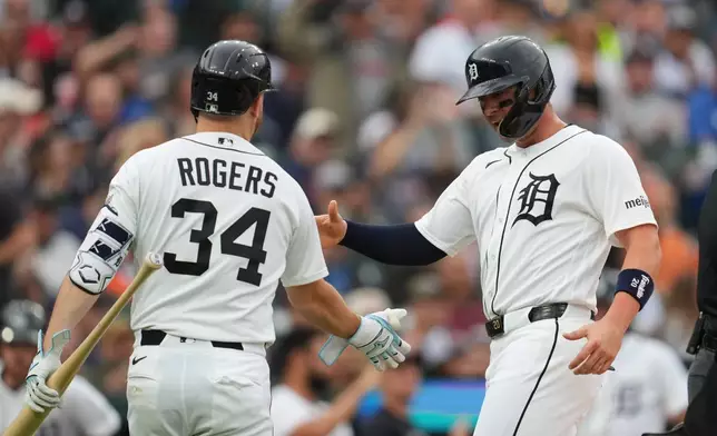 Detroit Tigers' Spencer Torkelson, right, celebrates scoring with Jake Rogers (34) against the New York Yankees during the second inning of a baseball game Wednesday, June 24, 2026, in Detroit. (AP Photo/Paul Sancya)