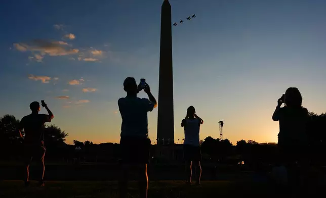 People record the F-35 formation flyover as it approaches the Washington Monument during the opening of the Great American State Fair on the National Mall, Wednesday, June 24, 2026, in Washington. (AP Photo/Carolyn Kaster)