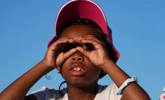 A child looks toward the stage before President Donald Trump speaks at the opening of the Great American State Fair on the National Mall, Wednesday, June 24, 2026, in Washington. (AP Photo/Julia Demaree Nikhinson)