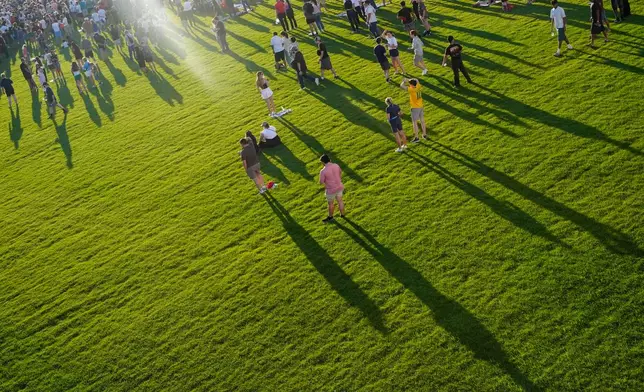 People arrive before President Donald Trump speaks at the opening of the Great American State Fair on the National Mall, Wednesday, June 24, 2026, in Washington. (AP Photo/Jen Golbeck)