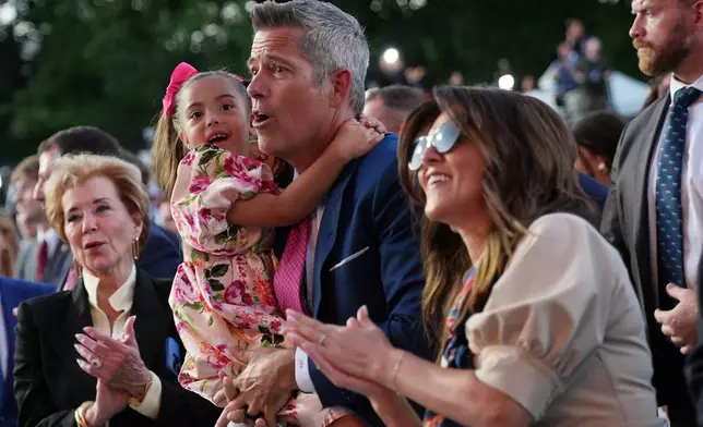 Transportation Secretary Sean Duffy and his family, listen to speakers at the opening of the Great American State Fair, Wednesday, June 24, 2026, in Washington, as Education Secretary Linda McMahon, looks on, left. (AP Photo/Jacquelyn Martin)
