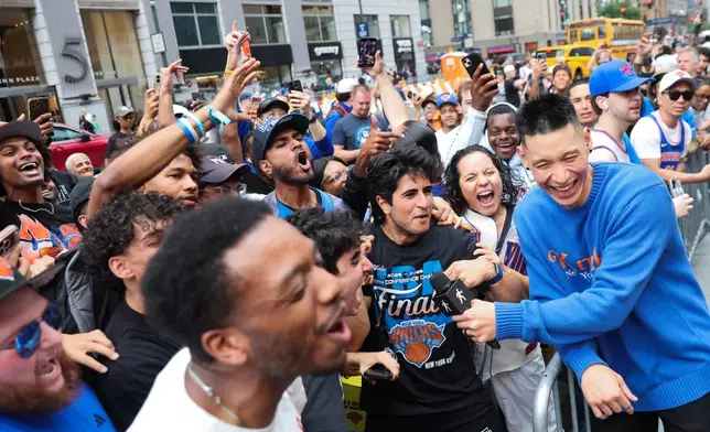 Former New York Knicks player Jeremy Lin, right, interviews Knicks fans outside of Madison Square Garden ahead of Game 4 of the NBA Finals between the Knicks and San Antonio Spurs, Wednesday, June 10, 2026, in New York. (AP Photo/Heather Khalifa)